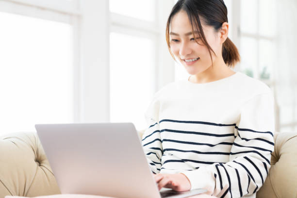 istock young asian woman using laptop 1495738137