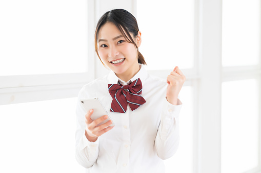 asian girl student using smart phone,School uniform,