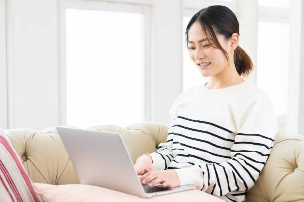 istock young asian woman using laptop 1495738211