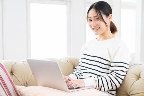 istock young asian woman using laptop 1495738224