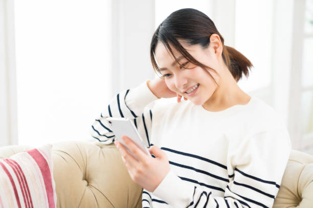 istock attractive Asian woman using a smart phone 1495738278