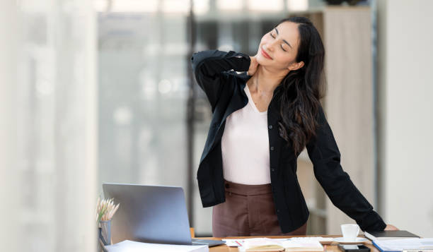 istock Asian working women relaxed from work and exercising at her desk office 1495738335
