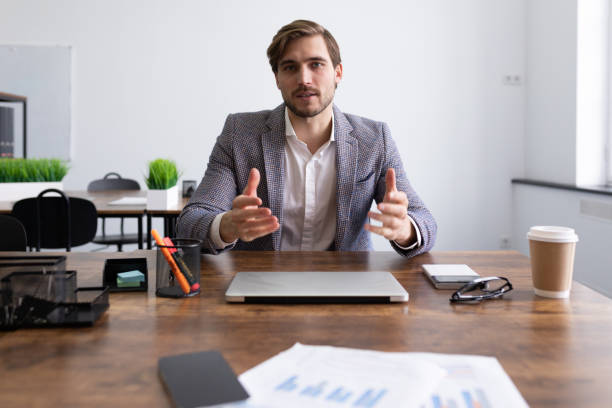 istock Caucasian attractive man in business clothes at an interview talks about his work experience 1495738448