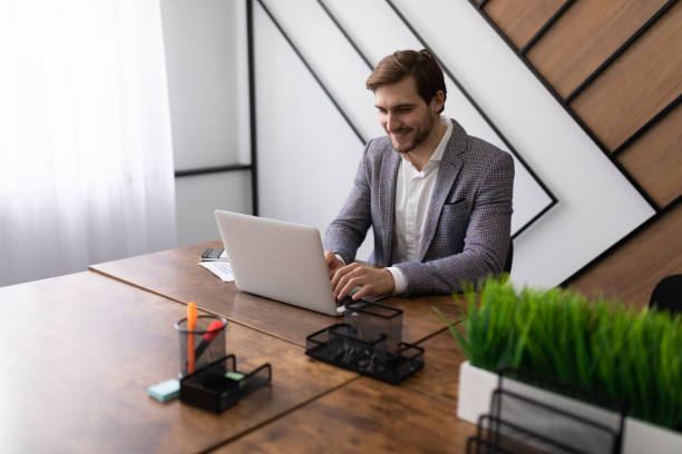 istock business lawyer studies the client's question while sitting at the table in the office and looking at the laptop 1495738560
