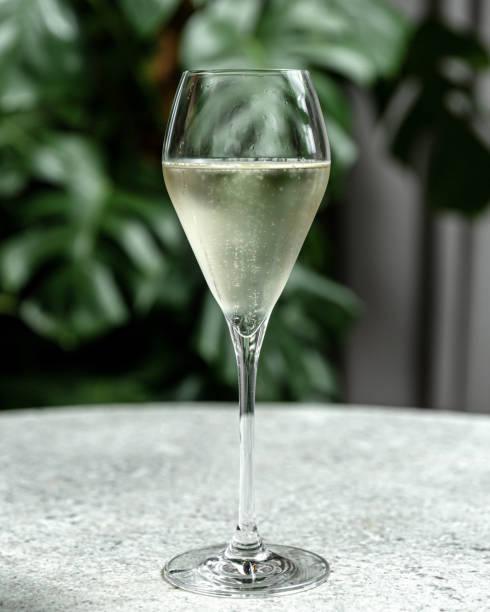 Glass goblet of cold champagne Refreshing cold transparent cocktail in glass cafe transparent glass table stock pictures, royalty-free photos & images