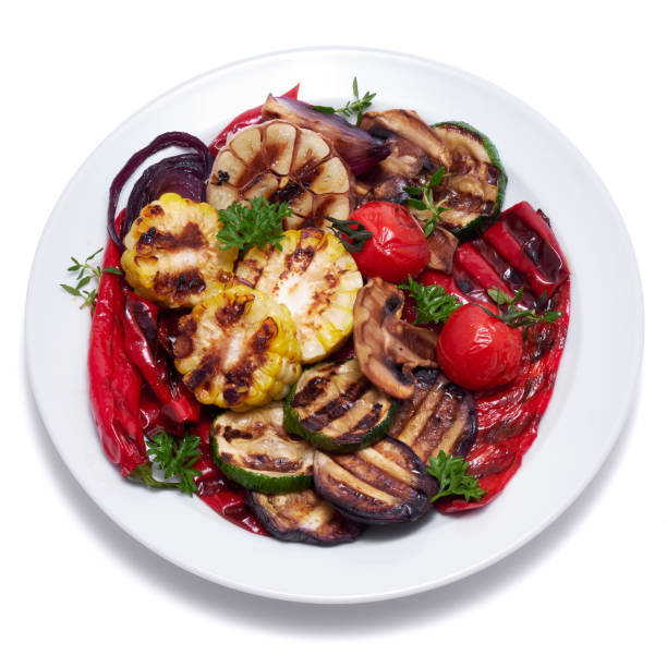 istock Grilled vegetables mix on a ceramic plate - zucchini eggplant onions corn mushroom tomato 1495740135