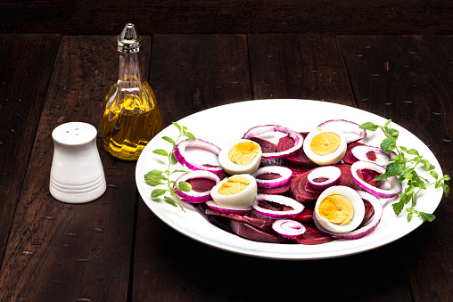 Delicious beet salad with boiled eggs ready to eat . Healthy lifestyle food prepared in the kitchen at home