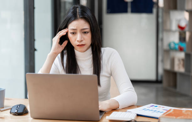 istock Stressed Woman working on laptop at home having a headache 1495742710