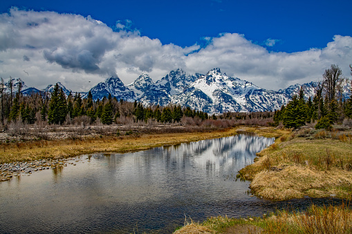 Teton mountain range reflected in the Snake river in the Yellowstone Ecosystem in western USA, North America. The nearest cities are Jackson and Cody, Wyoming, Denver, Colorado, Salt Lake City, Utah, Bozeman, Montana.