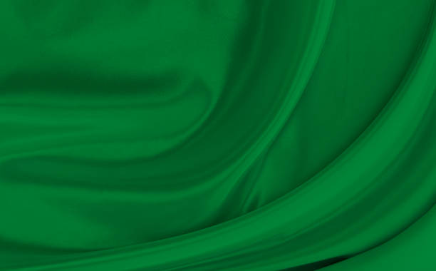 istock Black green satin dark fabric texture luxurious shiny that is abstract silk cloth background with patterns soft waves blur beautiful. 1495753860