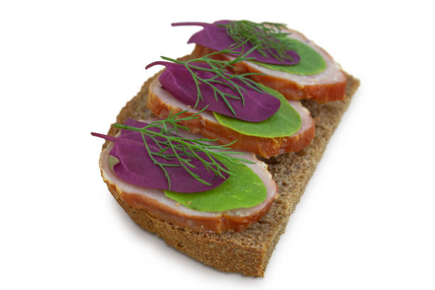 Sandwich with meat and herbs on a white background.