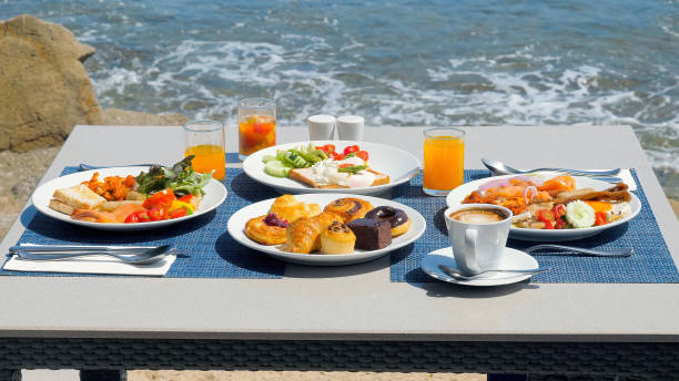 istock Luxury breakfast spread on table with a stunning tropical sea view 1495760942