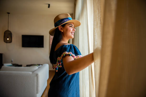 Tourist woman enjoying her room while talking on the cell phone. Tourist woman enjoying her room while talking on the cell phone. ejecutiva stock pictures, royalty-free photos & images