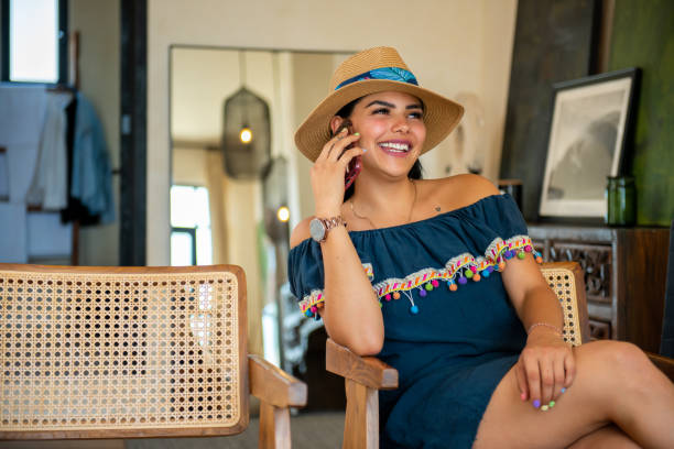 Tourist woman enjoying her room while talking on the cell phone. Tourist woman enjoying her room while talking on the cell phone. ejecutiva stock pictures, royalty-free photos & images