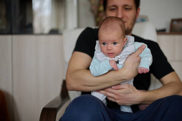 istock Father holding newborn baby 1495762440