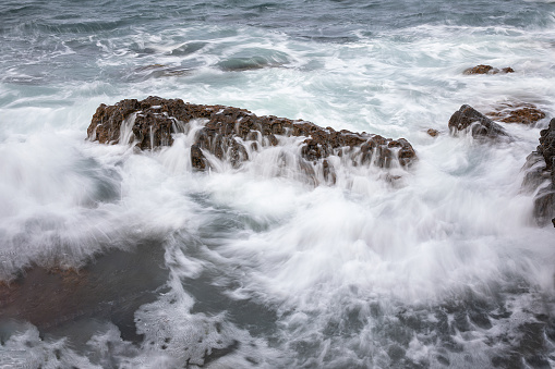 Huge storm waves crashing on the rocks. Location: Porto, west coast of Corsica, France.