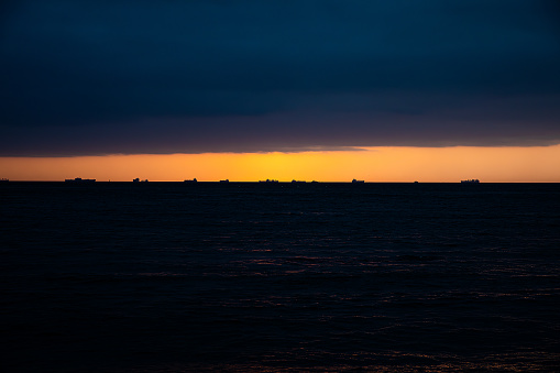 Crescent and clouds at sunset over the sea