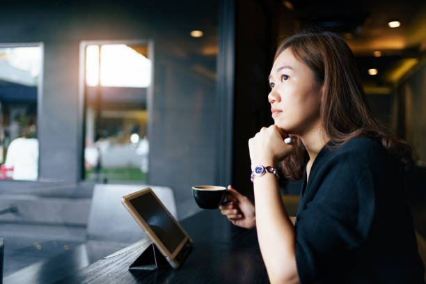 istock Woman working on laptop in coffee shop. 1495766873