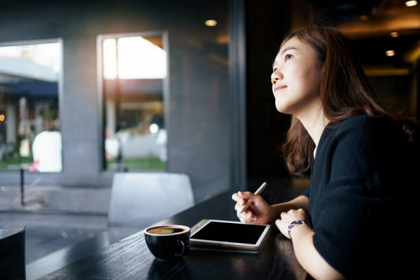 istock Woman working on laptop in coffee shop. 1495766874
