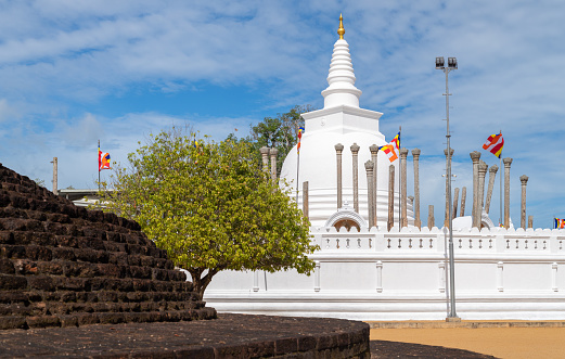 White walls and golden doors on heavenly balcony of white Phnom Oudong Buddhist stupa and temple in Cambodia