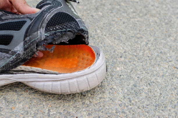 istock torn old black shoe on the back of the heel. 1495775041
