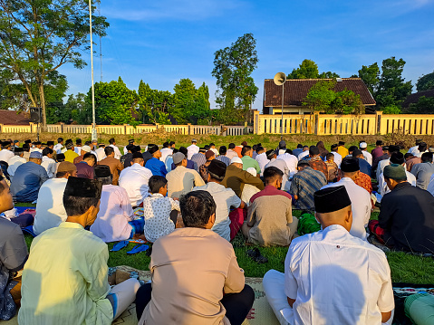 Peoples are gathering in the field to perform Eid Prayer with clear blue sky as the background. Yogyakarta, Indonesia, April 21, 2023.