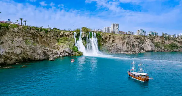 Photo of Duden waterfall dropping in Mediterranean Sea in Antalya, Lara Antalya in a bright sunny day, Lower Duden Waterfalls, high waterfall pouring into the sea, the waterfall in the city falls into the sea, turkey's famous tourism destination, the highest water