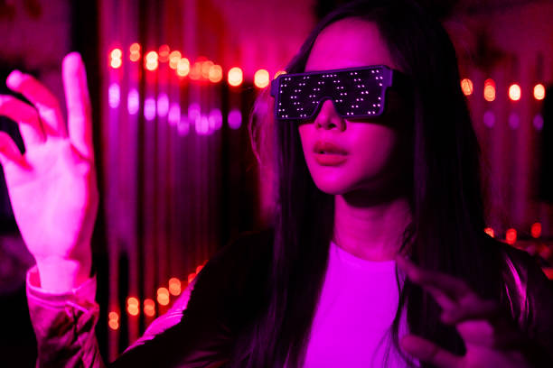 istock Asian woman  play game with neon light wall background. Concept of virtual reality, simulation, gaming and future technology. 1495789043