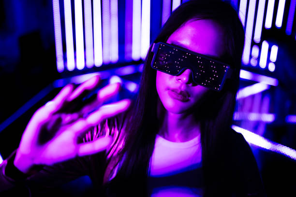 istock Asian woman  play game with neon light wall background. Concept of virtual reality, simulation, gaming and future technology. 1495789113
