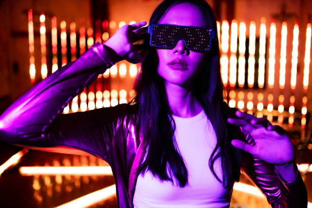 istock Asian woman  play game with neon light wall background. Concept of virtual reality, simulation, gaming and future technology. 1495789183
