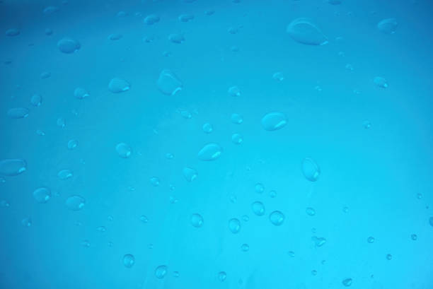 close up water drop on green inflatable pool or waddlng pool no people. close up drop of water.water drop background image.