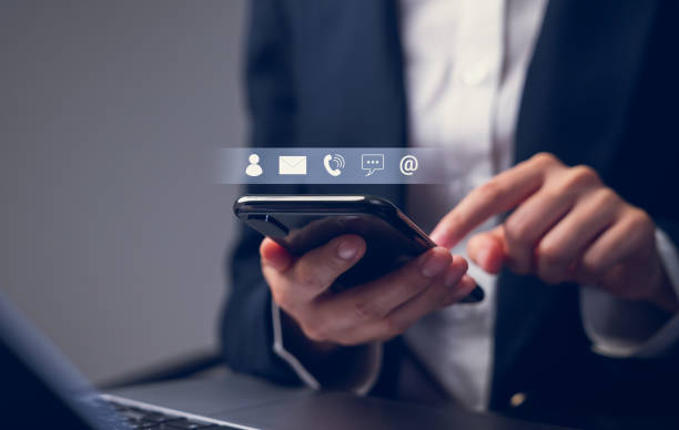 istock CONTACT US concept, Businessman using laptop and holding smartphone with icon customer support, email, message chat and phone. 1495798541