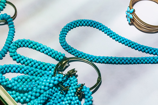 Collection of Sterling Silver Native American Bracelets with a Turquoise Nugget Necklace with shallow depth of field.