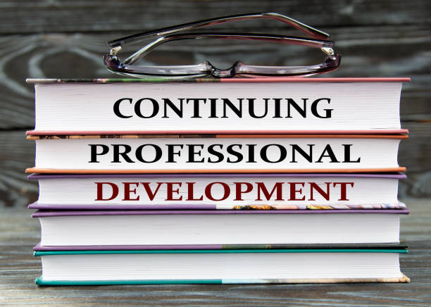 istock CONTINUING PROFESSIONAL DEVELOPMENT - words are written on books on a dark background 1495801594