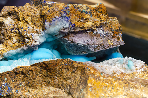 A fragment of the mineral lepidolite with a rough crystalline surface of a pinkish color. Isolated on white background.