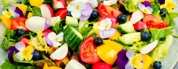 Salad with edible flowers, close up. stock photo