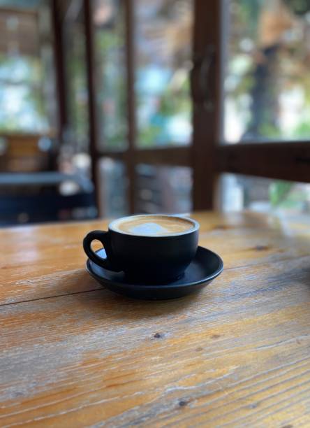istock Cup of coffee on wooden table 1495804365