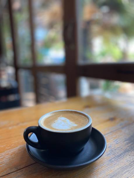 istock Cup of coffee on wooden table 1495804398
