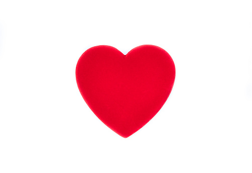 Heart shaped plate on a wooden background