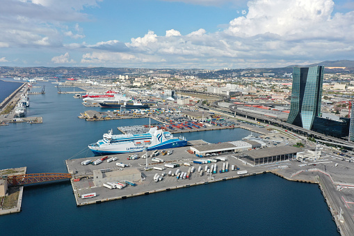 Marseille is the second most populous city in France, with 870,321 inhabitants. The image shows the modern part of the city with ferries captured during autumn season.