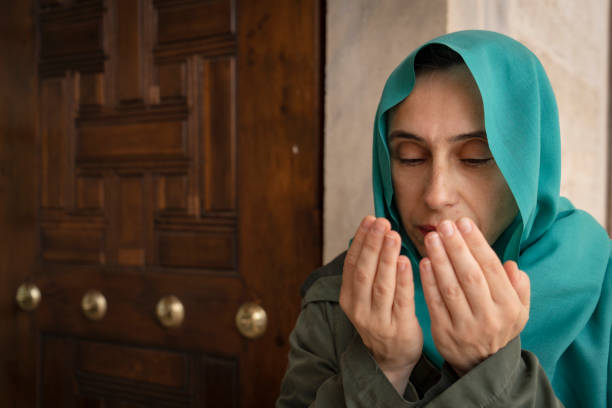 istock Woman praying at mosque 1495821144