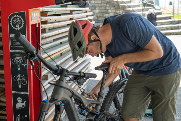 istock Mountain biker preparing his bike on the go 1495824005