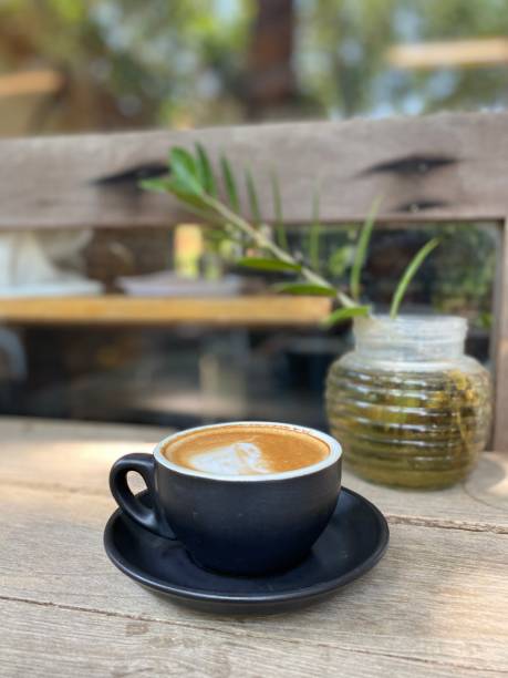 istock Cup of coffee on wooden table in cafe 1495824175