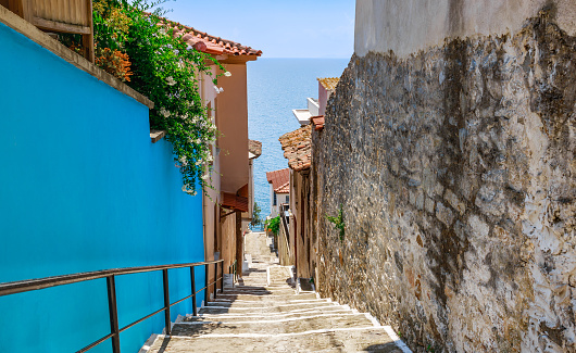 Narrow street and sea in old town Kavala, Macedonia, Greece, Europe