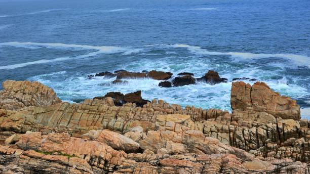 istock waves crashing on rocks at Pitstop Cape Town. South Africa 1495828254