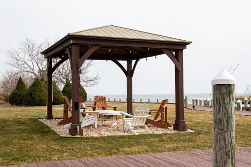 Wooden gazebo pavilion in a backyard waterfront property on Long Island New York.
