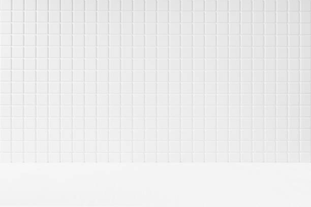 istock White abstract bathroom interior or stage mockup with white tiny tile wall, wood shelf for display, presentation of cosmetics products, goods, design. Modern stage in summer mediterranean style. 1495834765