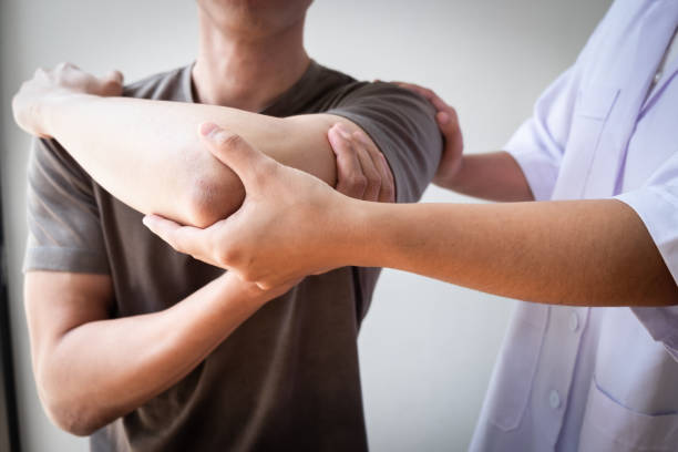 istock Therapist treating a male injured by rotator cuff stretching method. 1495836640
