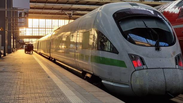 istock White modern high speed train on railway station at sunset. 1495841005