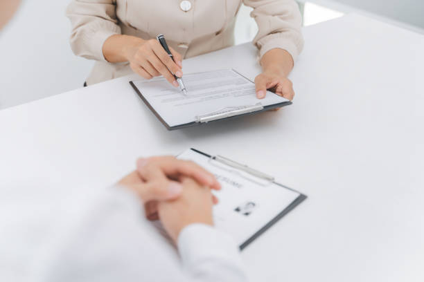 istock Examiner reading a resume during job interview at office 1495841168